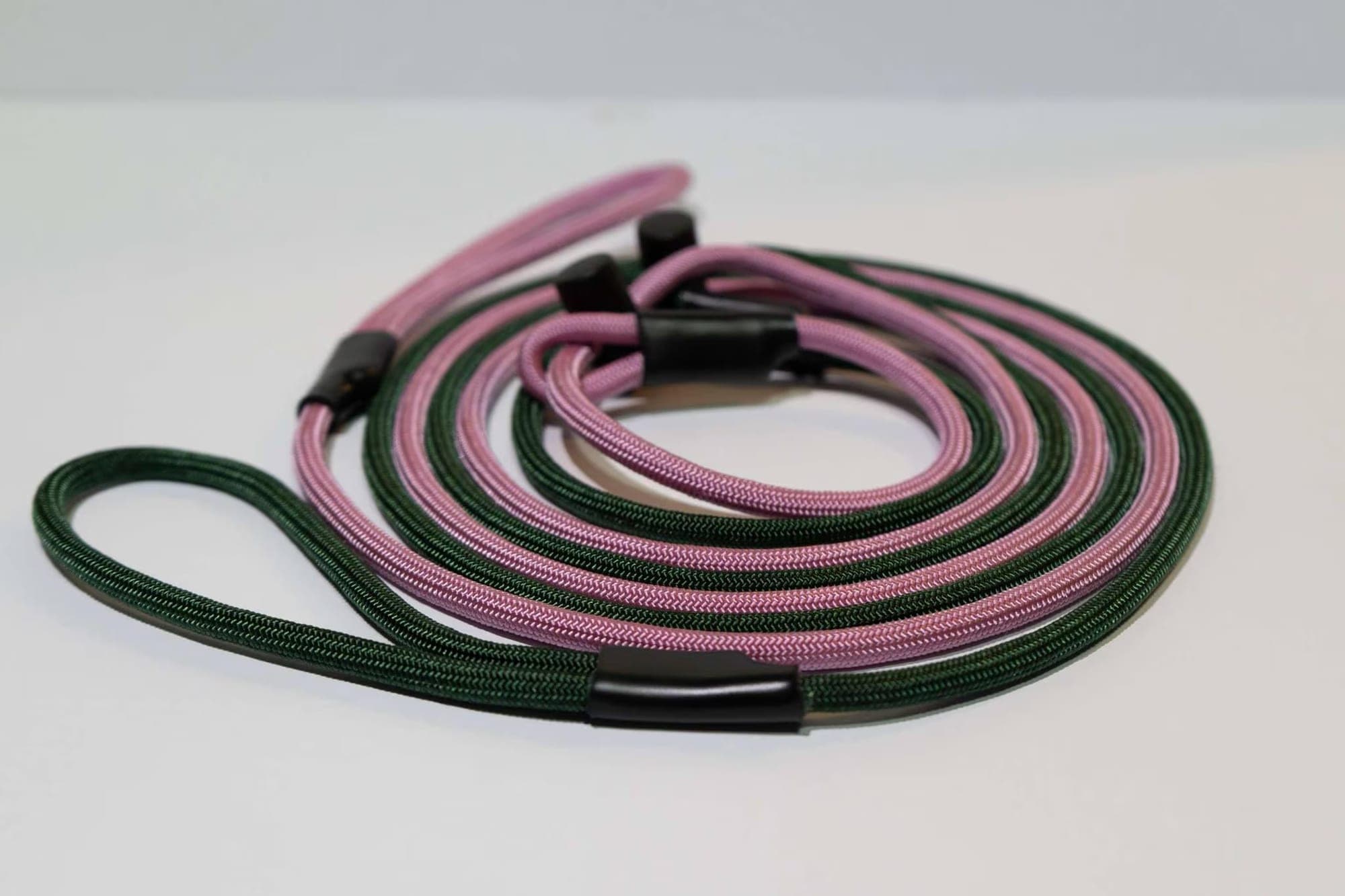 Two coiled paracord slip leashes, one pink and one dark green, thumbnail